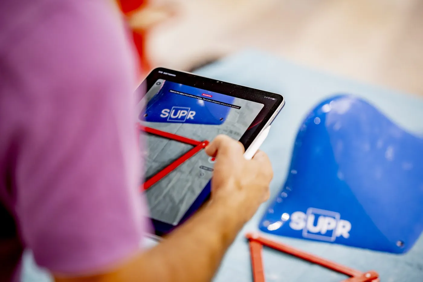 Two setters discuss a route shown on a tablet