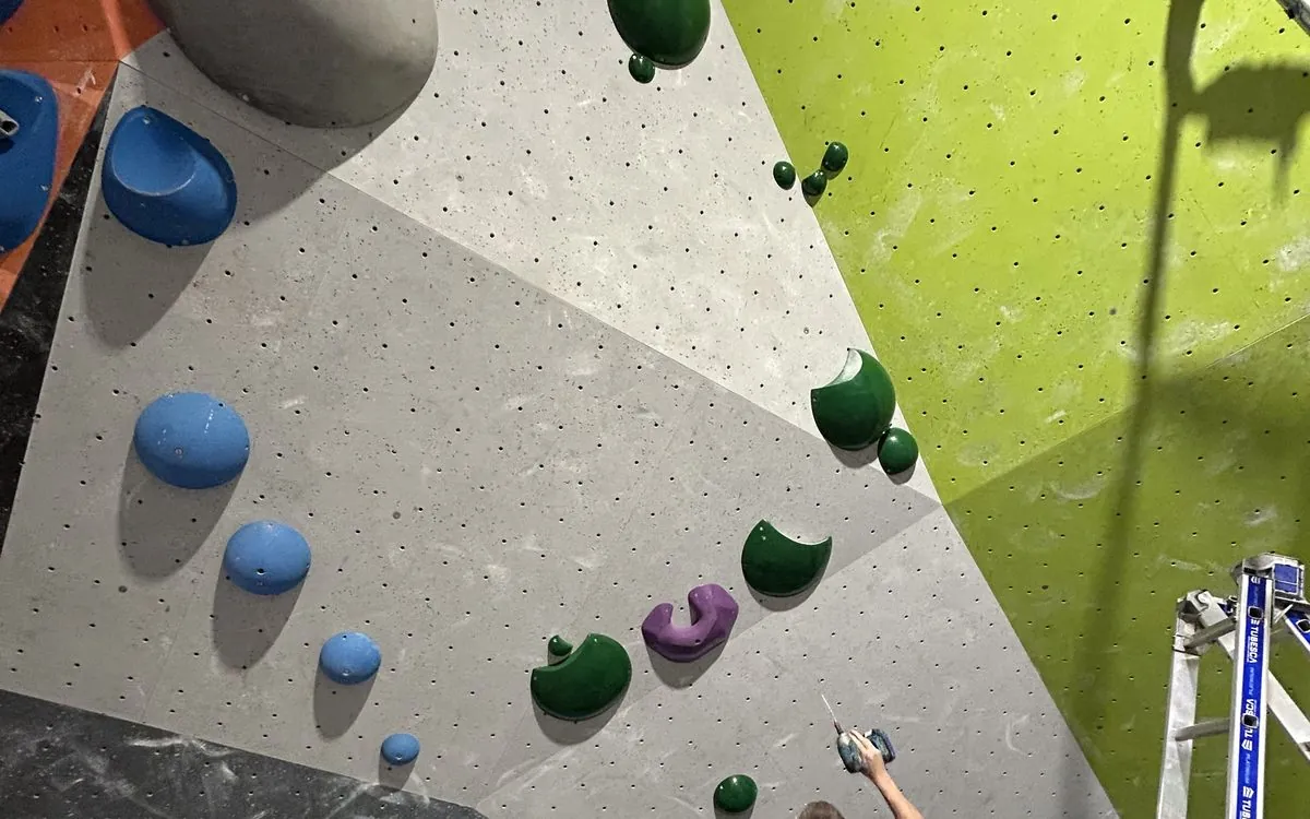 A bouldering wall with its holds, seen from below